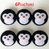 Six black and white owl-shaped wool dryer balls, each about 7 cm in diameter.