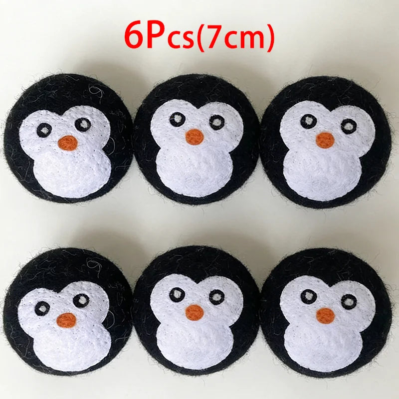 Six black and white owl-shaped wool dryer balls, each about 7 cm in diameter.