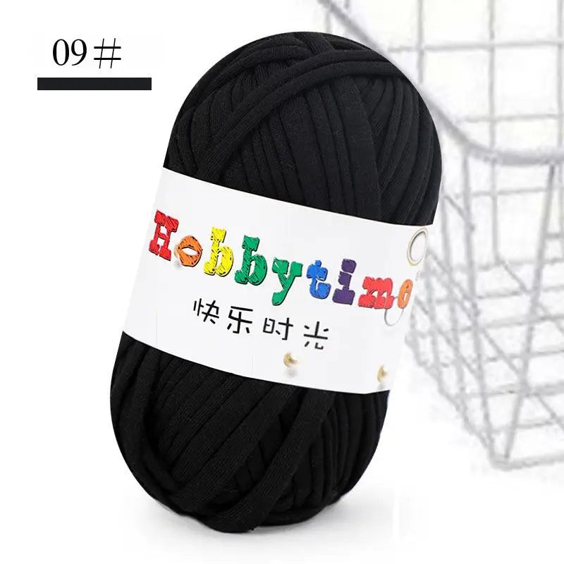 Black soft T-shirt yarn for crochet and knitting used in a craft context.