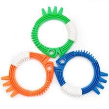 A set of four plastic rings in green, white, orange, and blue for a pool dive and grab play set.
