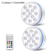 A round submersible LED pool light fixture with multiple lenses and a separate controller remote.