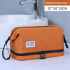 Vibrant orange large travel toiletry bag with wet and dry compartments shown next to a bathroom sink.