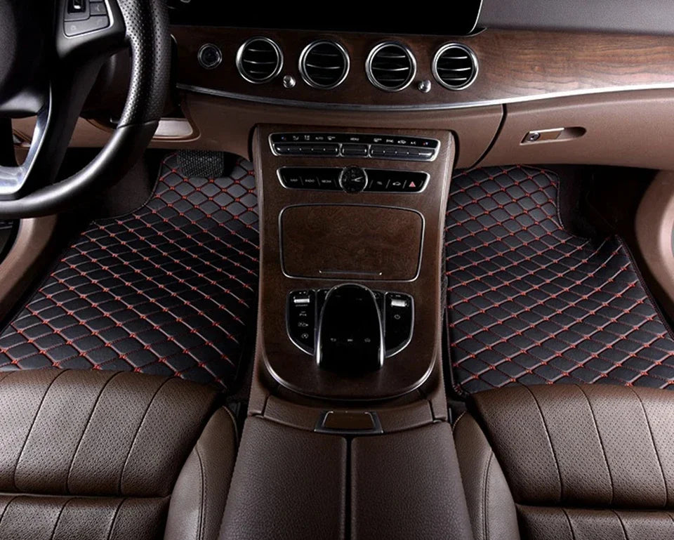 Interior view of a car showing leather seats, wood trim, and an automatic climate control panel.