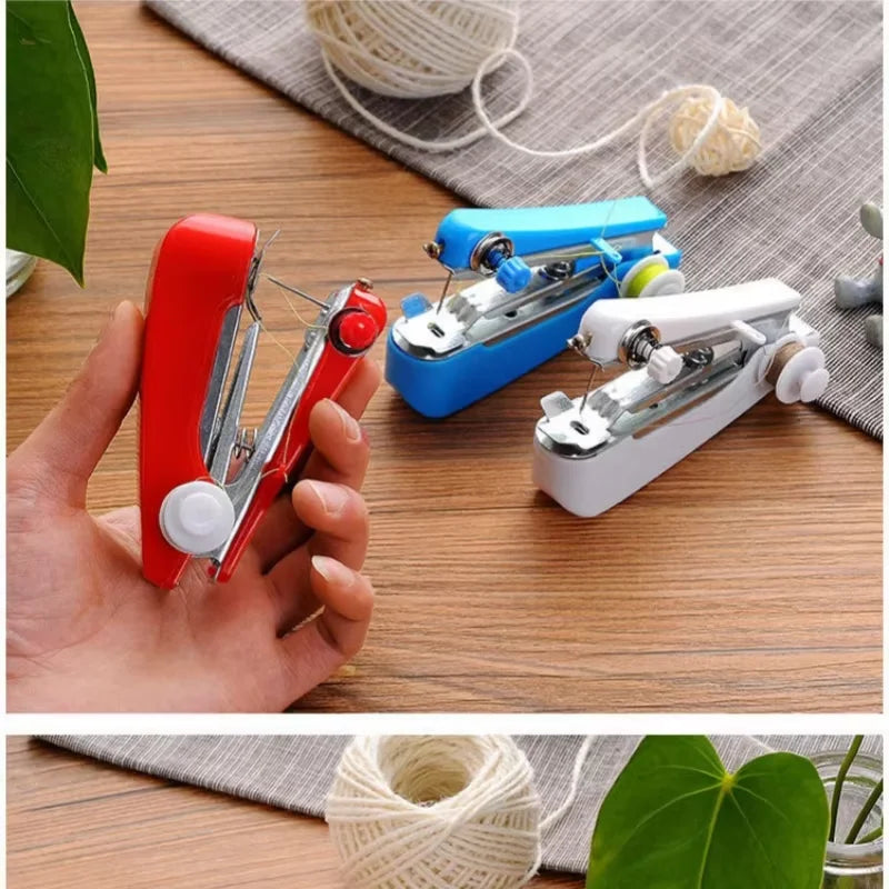 Three portable handheld sewing machines in red, blue, and white are displayed on a wooden surface with yarn nearby.