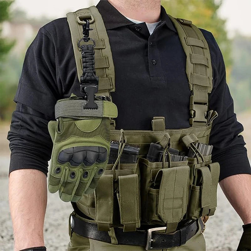 A hand-mounted work glove clip with a carabiner attached to a tactical vest and paracord lanyard.