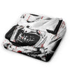 A black and white vintage art the clown coral fleece throw blanket folded and displayed.