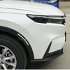 Front view of a white Honda CR-V showing the headlight and tire.