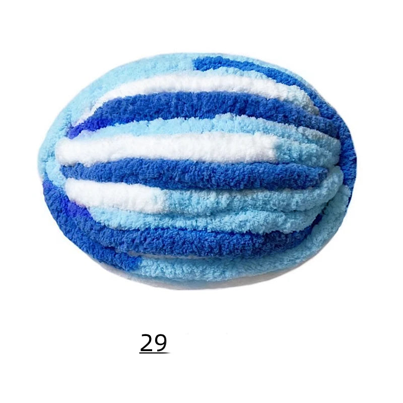 A ball of extra thick blue and white chenille yarn with horizontal stripes.