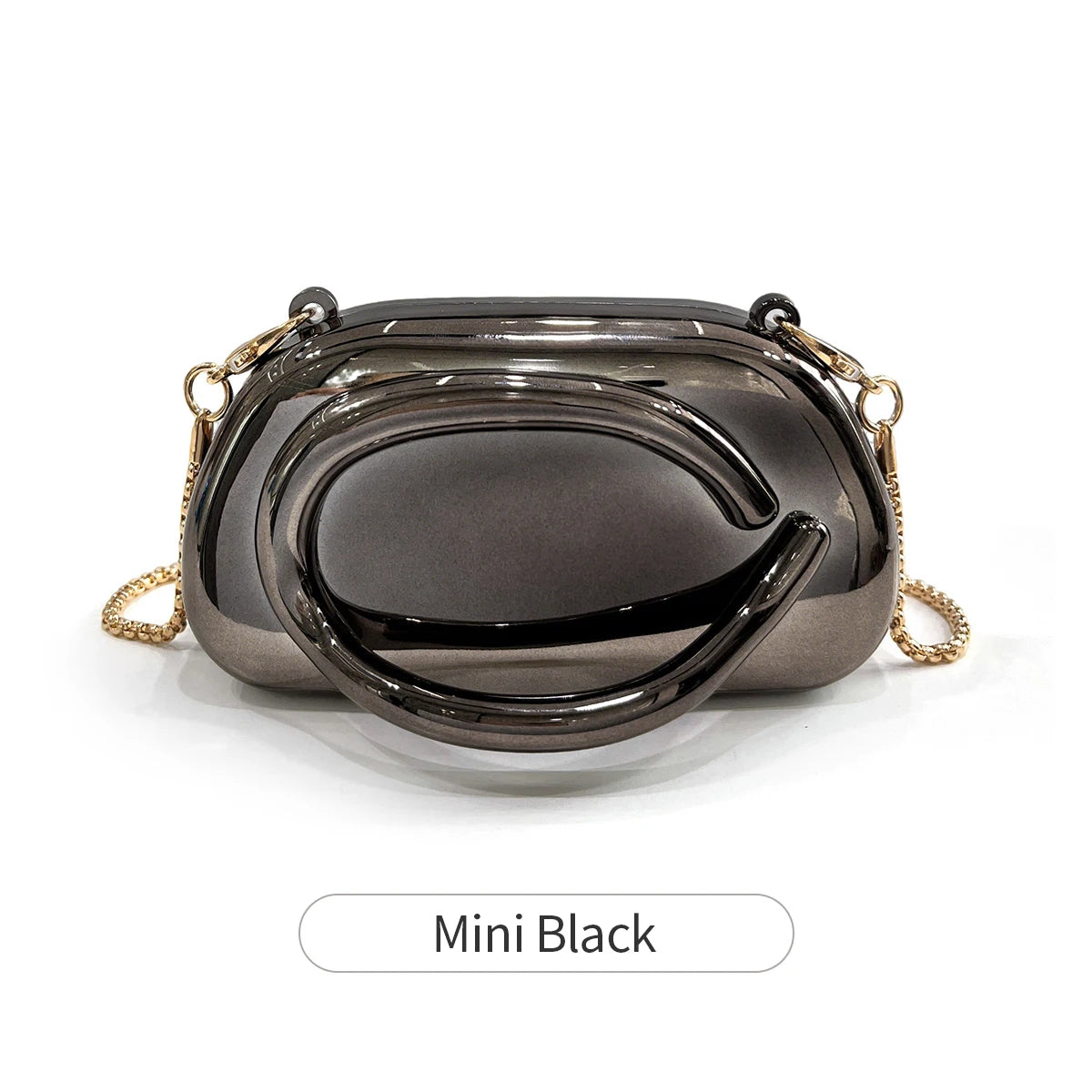 A small black clutch bag with gold metal hardware shown from above.