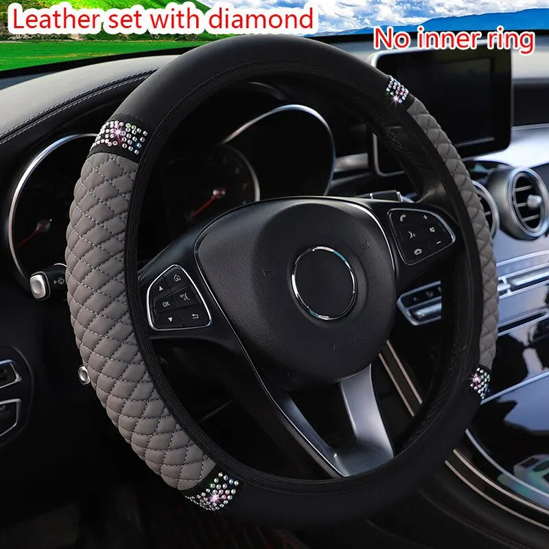 Black steering wheel cover with diamond accents installed in a car interior.