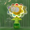 A yellow sunflower-shaped bubble machine with flashing lights and clear bubbles on a green surface.
