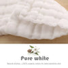 A close-up of white, quilted organic cotton washcloths with a natural dye detail.
