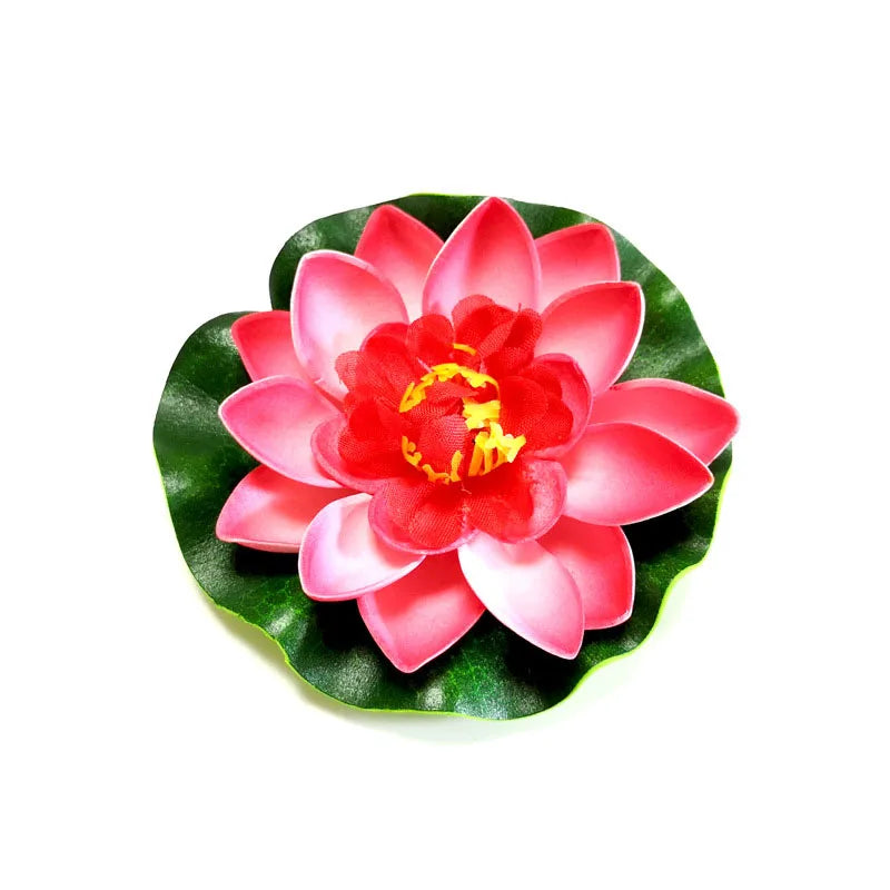 A vibrant pink and red lotus flower with green leaves floating on white.