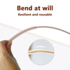 A hand is bending a flexible silicone straw cleaning brush to show its resilience and reusable nature.