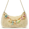 A beige straw beach shoulder bag adorned with colorful ocean shell charms.