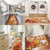 A decorative area rug featuring Thanksgiving pumpkins and maple leaves in orange, yellow, and green tones.