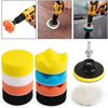 A set of three yellow, white, and orange self-adhesive polishing pads for car detailing.
