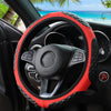 Close-up view of a red quilted steering wheel cover on a black car interior.