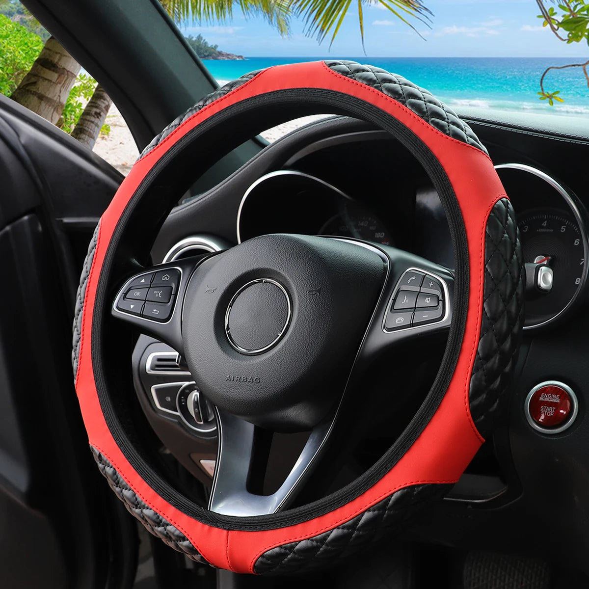 Close-up view of a red quilted steering wheel cover on a black car interior.