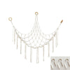 A white mesh hammock with hanging strands is displayed, used as a bohemian plush toy storage organizer.