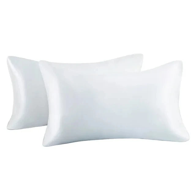 A set of two white silky satin pillowcases for hair and skin.
