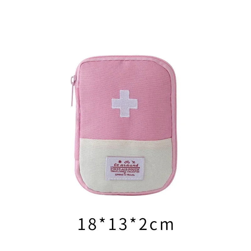 A pink portable mini first aid kit organizer bag with a white cross symbol on the front.