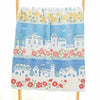 A light blue towel featuring a white embroidered cartoon cityscape with pink and green floral accents.