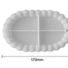 A white silicone tray mold with a ruffled edge and a cross-shaped depression for crafting materials.