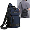 A dark blue multifunctional chest bag with black straps and buckles is shown next to a person wearing a gray shirt.