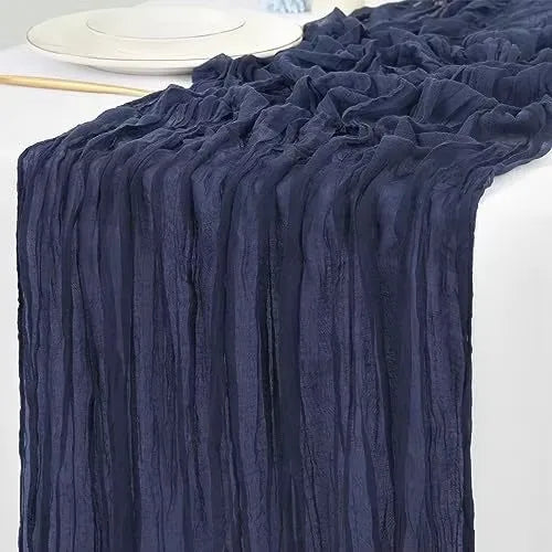 Navy blue cotton gauze table runner with vertical pleats and ruffled edges