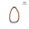 A close-up of a natural beige rope tieback with a silver magnetic clasp.
