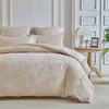 A beige Nordic leaf print duvet cover set displayed on a bed with white upholstered headboard and decorative molding.