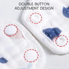 Close-up of white muslin bandana bibs with double button adjustment designs and blue floral patterns