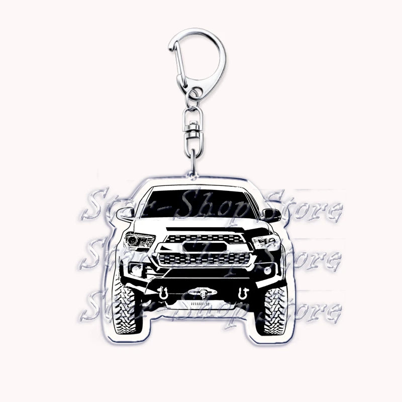 Silver metal key ring with a detailed off-road truck charm featuring a rugged vehicle face.