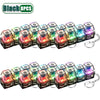 A set of eight black LED clickable fidget keychains with a keyboard design.