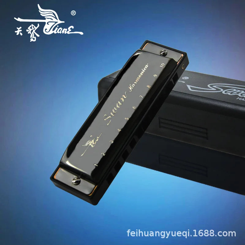 A black 10-hole C key diatonic harmonica with a case is shown diagonally against a blue background.
