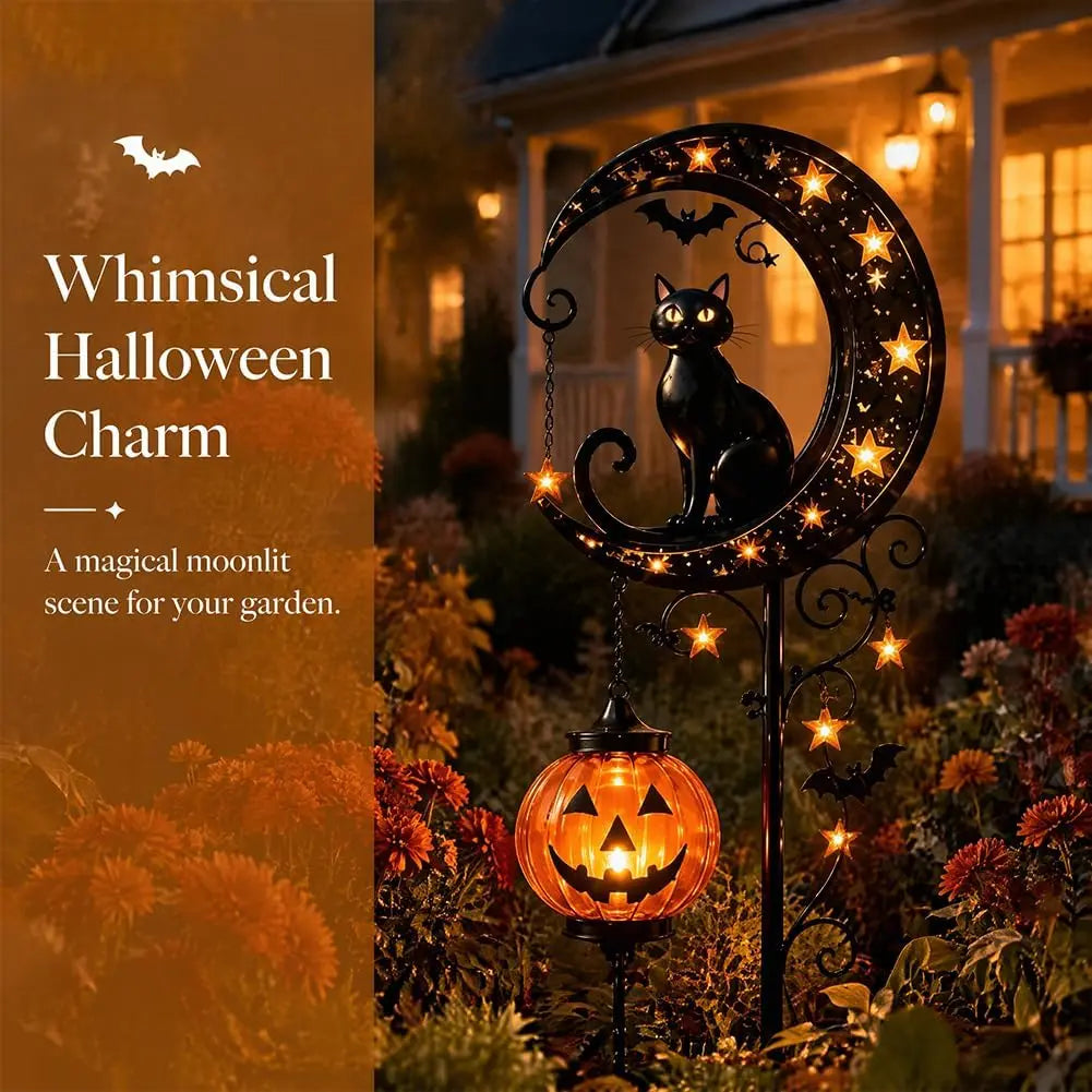 A black cat silhouette and an orange pumpkin light decoration on a garden stake for Halloween.