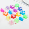 A collection of colorful squishy cat paw fidget toys in various shades of pink, purple, green, and blue.