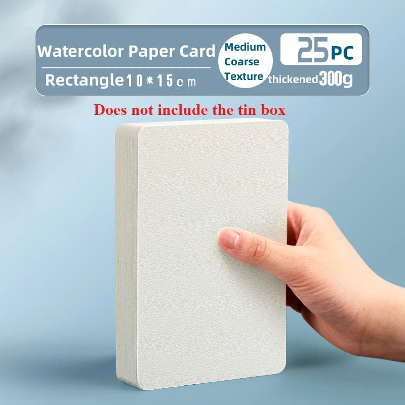 A hand holds a rectangular watercolor paper card with a coarse texture, showing the product dimensions and details.