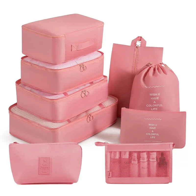 A set of pink travel packing cubes and storage organizer bags for packing and organization.
