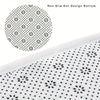 Close-up view of a white area rug with a non-slip dot design pattern.