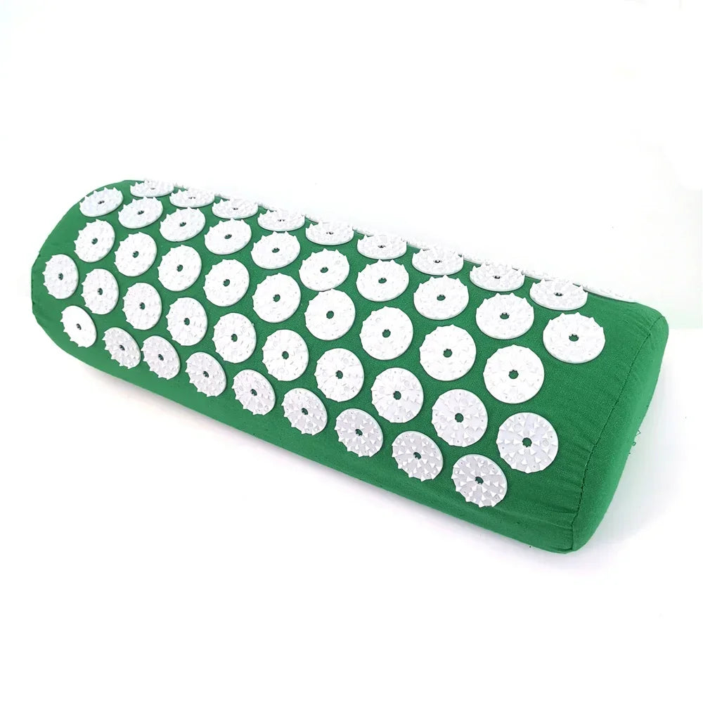 Green acupressure mat with white discs and a matching pillow for pain relief