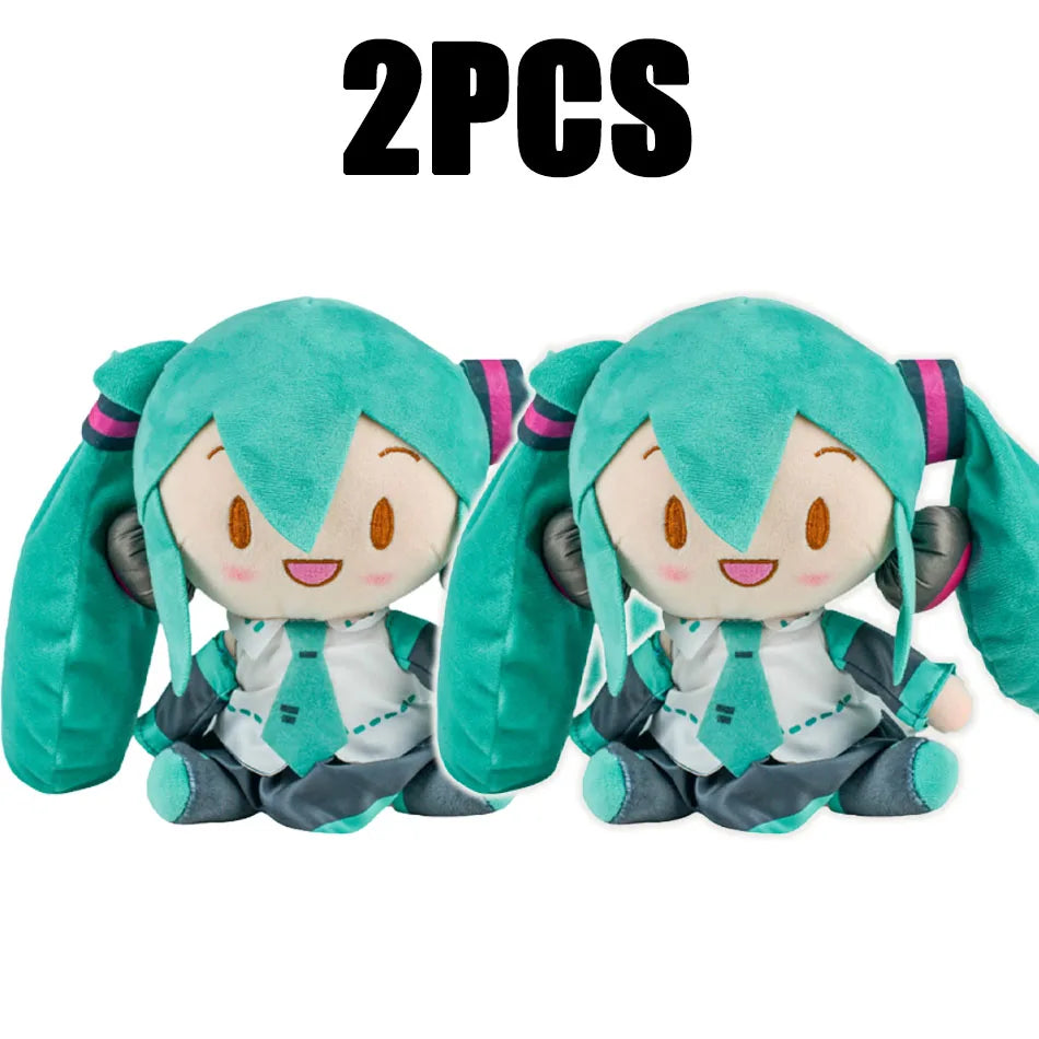 Two soft teal Hatsune Miku plush dolls with pink accents.