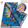 A bolt of pink glitter African wax print fabric featuring blue and yellow floral patterns.