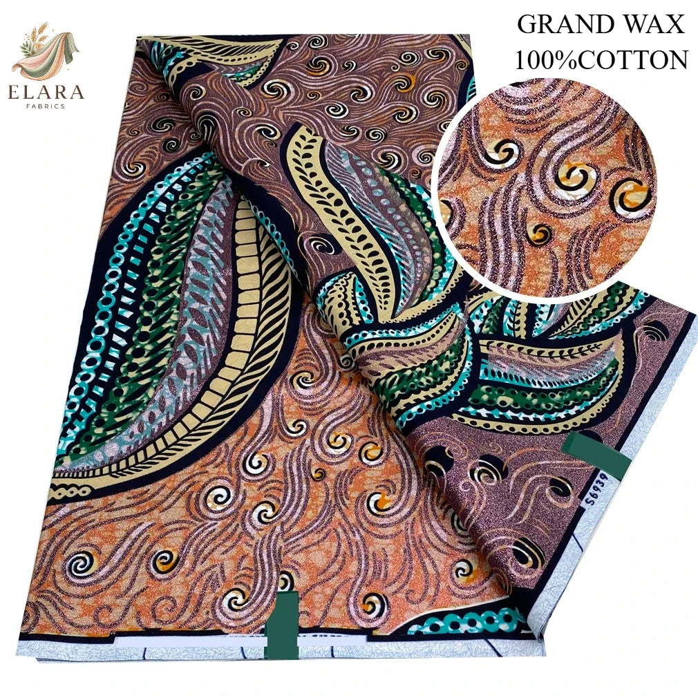 A roll of orange and brown African wax print fabric with swirling patterns, labeled as Grand Wax 100% Cotton.