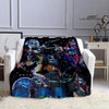 A black and blue printed flannel throw blanket featuring various stylized band imagery.