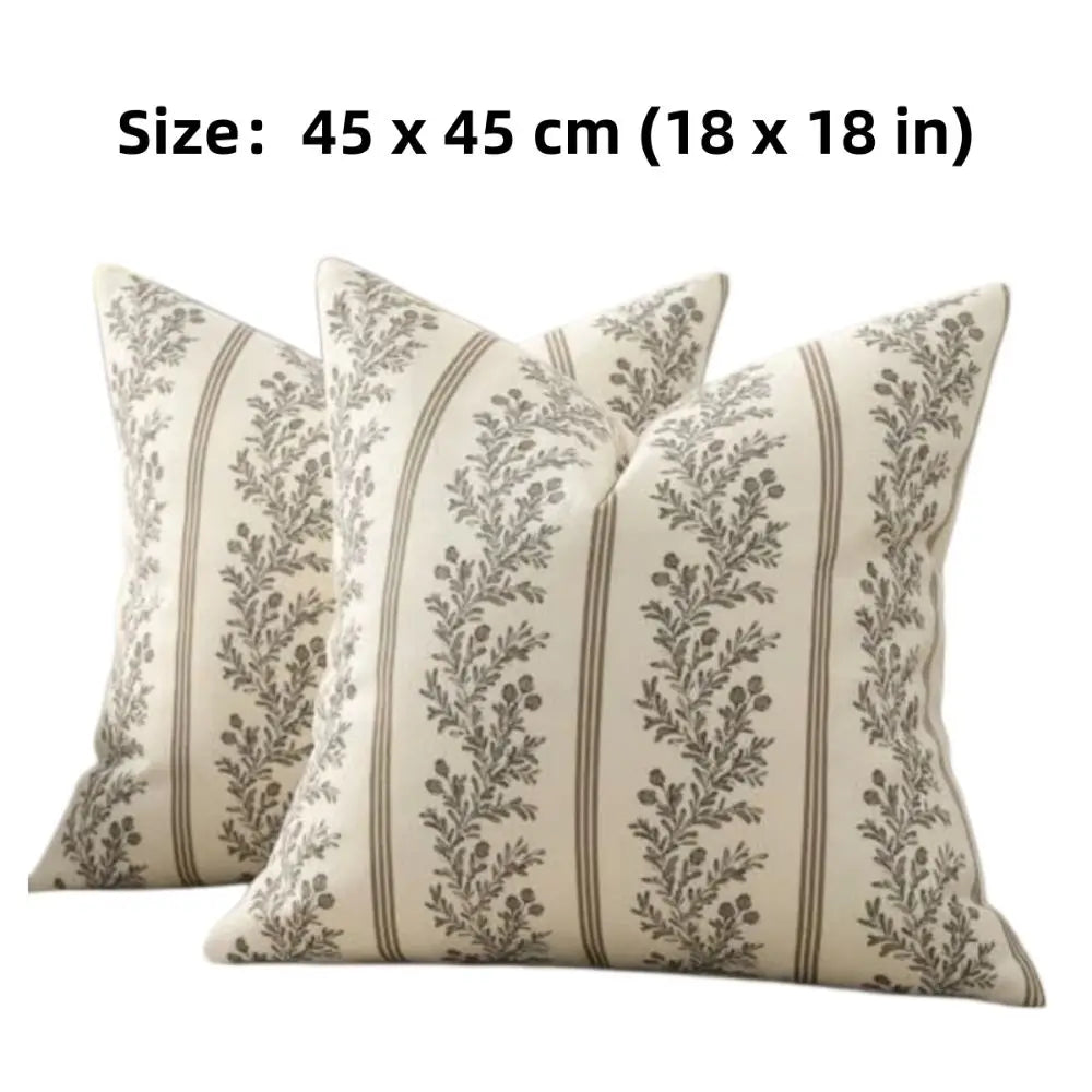 A cream-colored throw pillow cover with a gray floral pattern and vertical stripes.