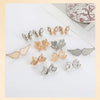 A collection of gold and silver no-sew adjustable waist tighteners for jeans and skirts.