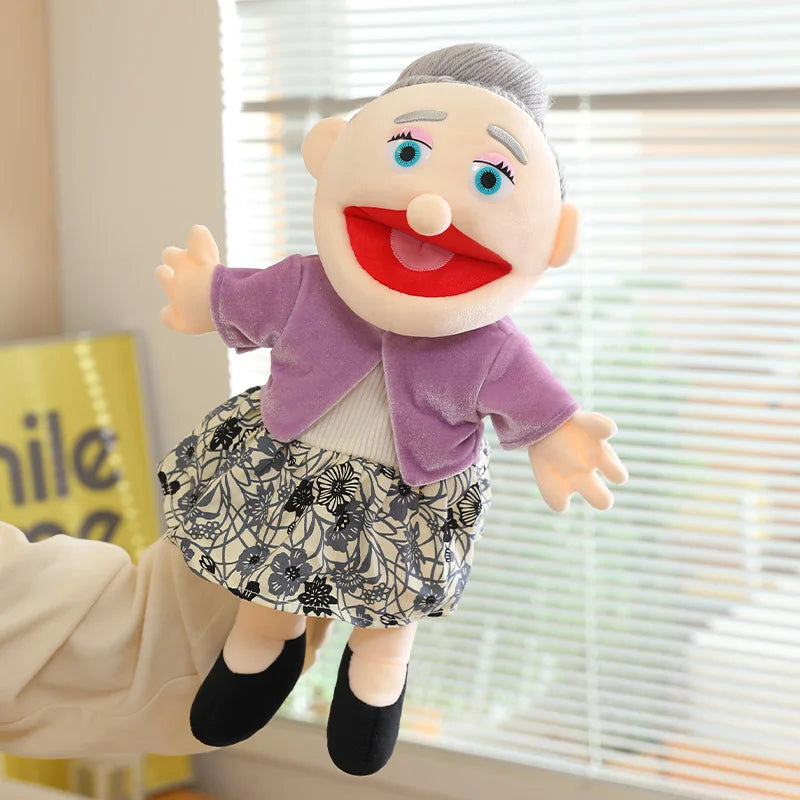 A soft plush full-body hand puppet of an elderly man with a purple jacket and patterned skirt.