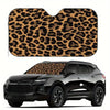 A leopard print car windshield sunshade is shown on a black SUV.